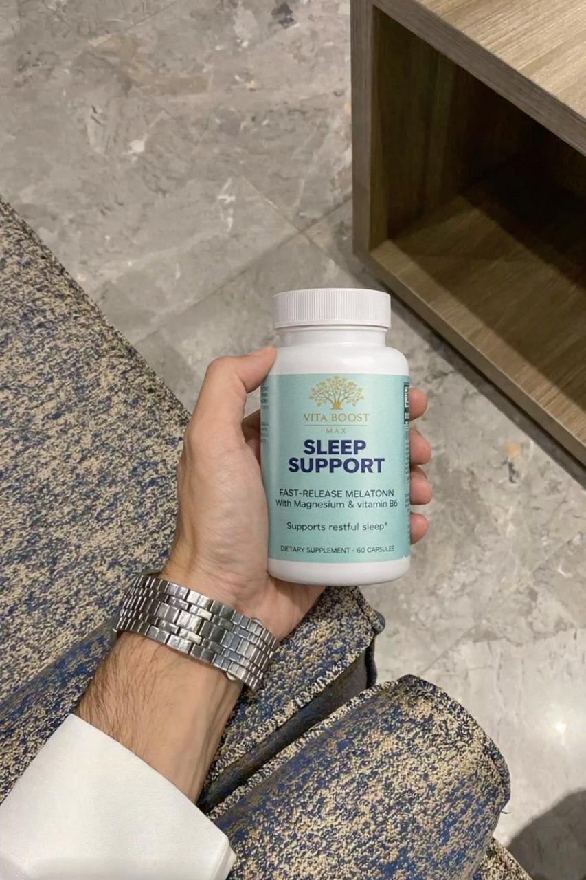 A customer holding a bottle of Vita Boost Max Sleep Support, showcasing the fast-release melatonin and magnesium label for natural sleep assistance.